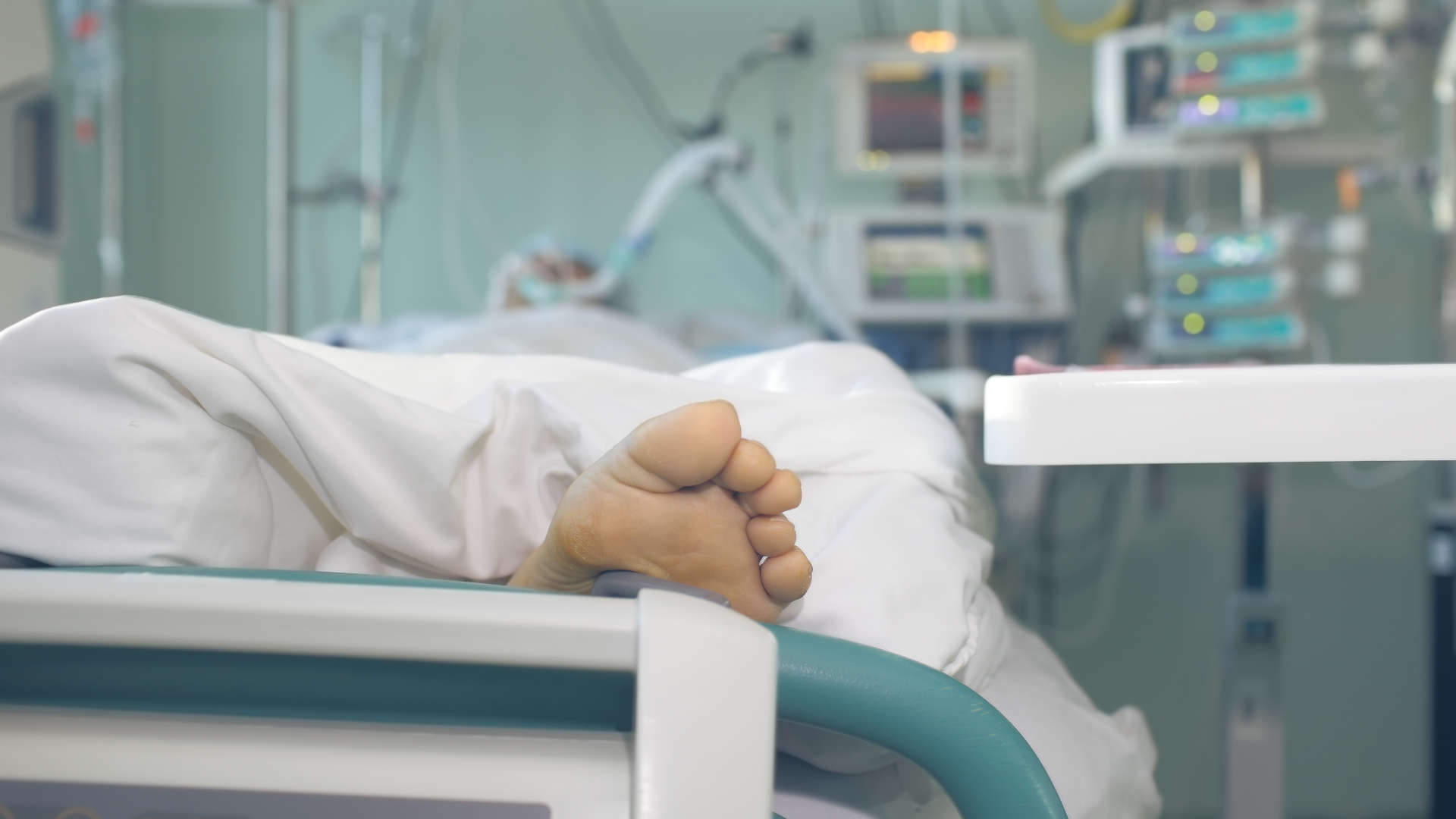 Foot protruding from end of bed