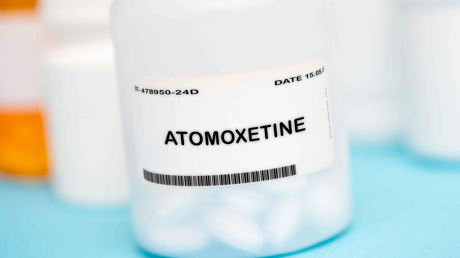 White container with atomoxetine pills